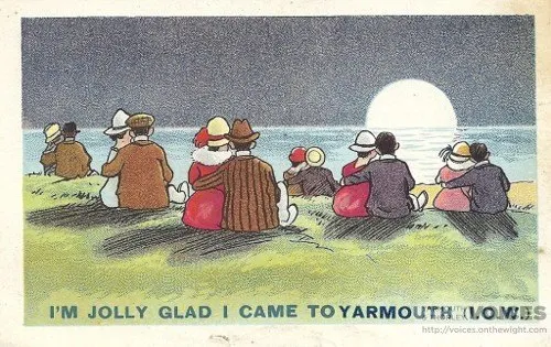 Old comic seaside postcard of holidaymakers seen from behind, sitting on a bank looking out to sea under a full moon, captioned “I’m jolly glad I came to Yarmouth”.