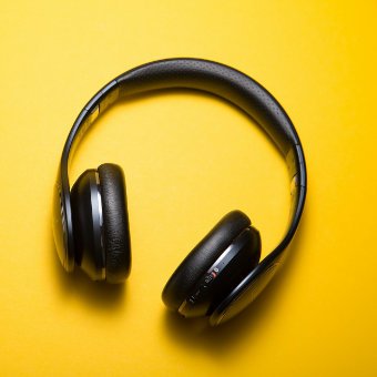 Wireless headphones on a yellow background