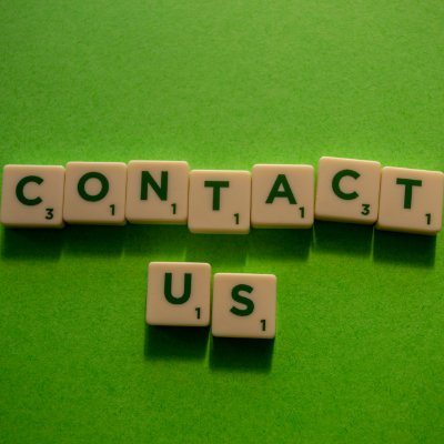contact us in scrabble letters on a green background